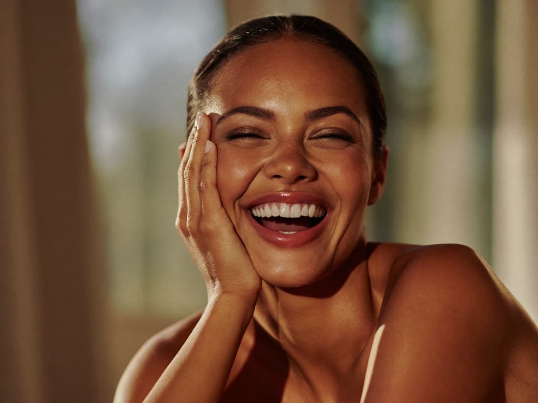 A woman with a radiant, confident smile